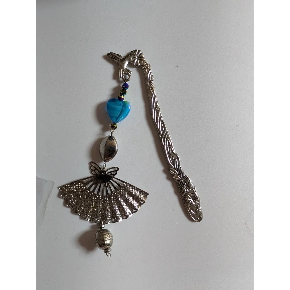 metal hook bookmark with a beaded charm featuring a fan pendant and a blue heart
